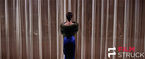 Gif of Natalie Portman in Gypsy: the curtains are opening and she is walking onto stage 